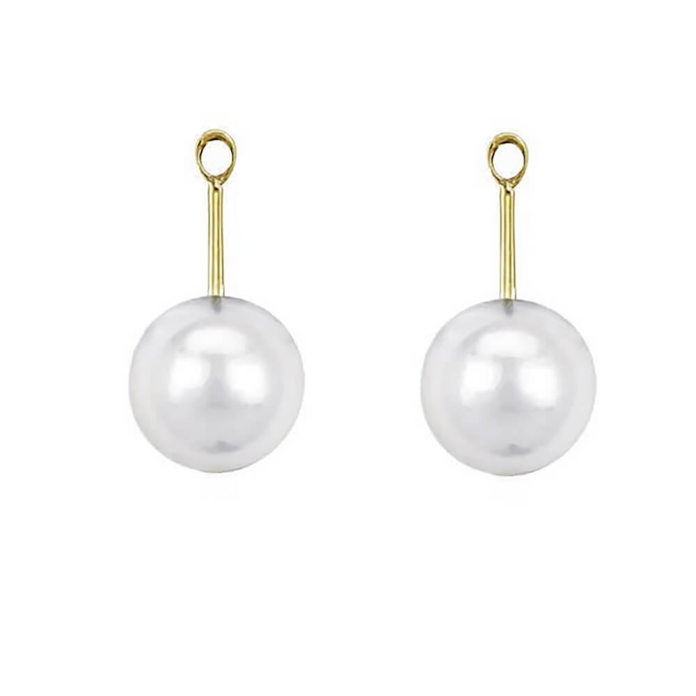 A pair of earring jackets featuring large, round white freshwater pearls suspended from slim 18K yellow gold posts with circular loops at the top, set against a plain white background.