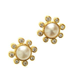 Pair of 19K gold earrings with Akoya Pearl centers on a white background