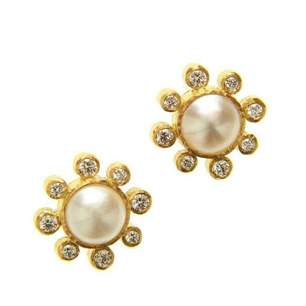 Pair of 19K gold earrings with Akoya Pearl centers on a white background