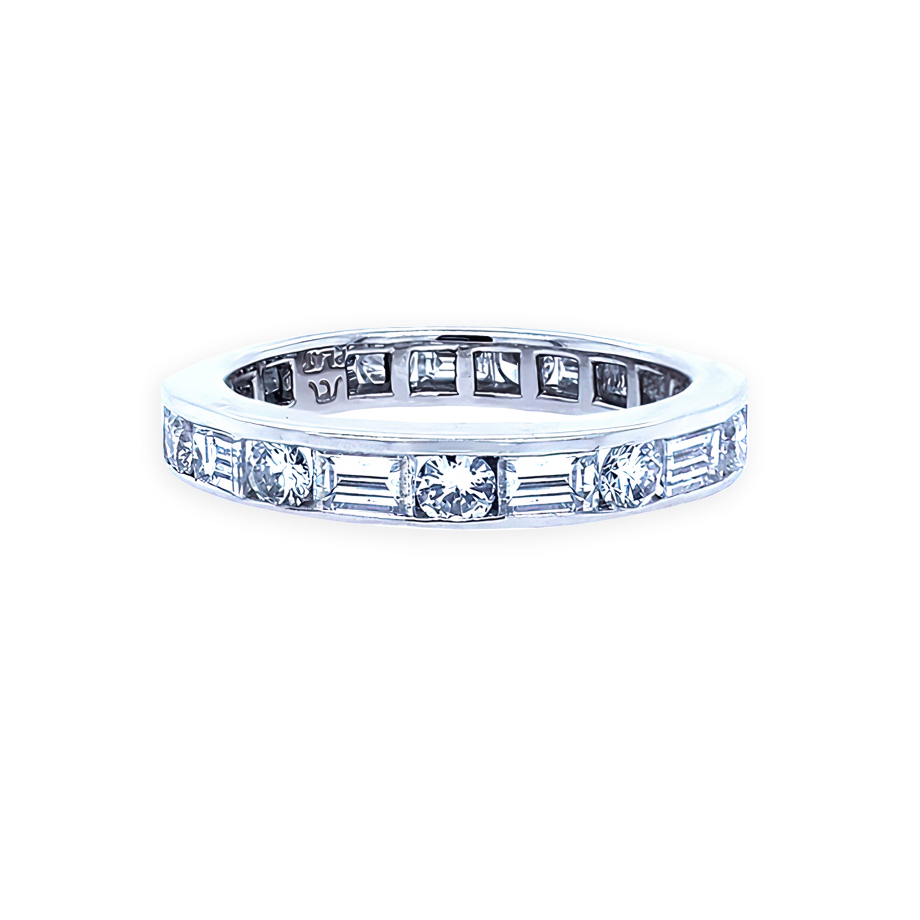 A platinum eternity band with baguette and round diamonds set around its circumference.