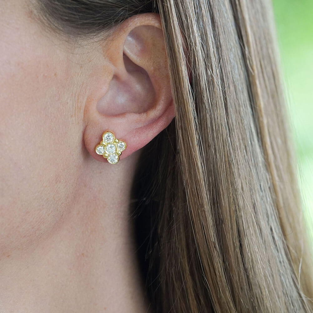 Close-up of a woman wearing Anderson gold and diamond earring designed by Laura Pearce.