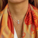 Close-up of a woman wearing 2 Platinum diamond necklaces designed by Laura Pearce.