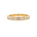 An 18K yellow gold band featuring princess cut diamonds arranged in a line.
