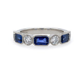 Ring with sapphire gemstones and diamonds on a white background