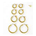 Four Sets of gold hoop earrings on a white background