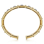 A 14K gold cuff bracelet featuring a segmented design, beaded borders, and clear round diamonds, shown on a clean white background.