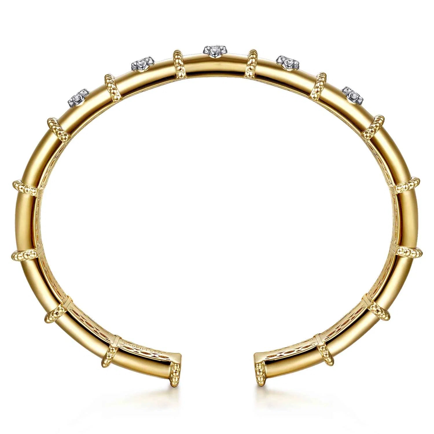 A 14K gold cuff bracelet featuring a segmented design, beaded borders, and clear round diamonds, shown on a clean white background.