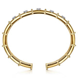 A 14K gold cuff bracelet featuring a segmented design, beaded borders, and clear round diamonds, shown on a clean white background.