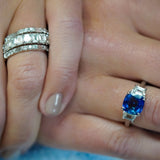 Custom designed ring featuring a cushion cut sapphire and trapezoid side diamonds in a platinum setting