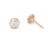 A pair of rose gold stud earrings with a clear, round-cut diamond in the center.