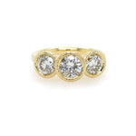 18K Gold ring with three diamonds on a white background