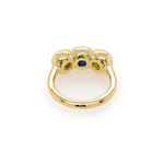Custom designed 18K Gold ring with a central blue sapphire gemstone and side diamonds