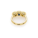 Custom designed 18K Gold ring with a central blue sapphire gemstone and side diamonds
