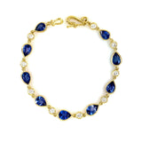 An 18k yellow gold bracelet featuring alternating blue sapphire and clear diamond stones.