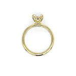 An 18K yellow gold ring with a single oval-cut clear diamond in a prong setting, shown against a plain white background.