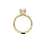An 18K yellow gold ring with a single oval-cut clear diamond in a prong setting, shown against a plain white background.