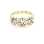 18K Gold ring with three clear diamonds on a white background