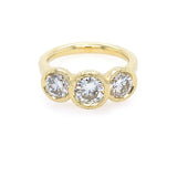 18K Gold ring with three clear diamonds on a white background