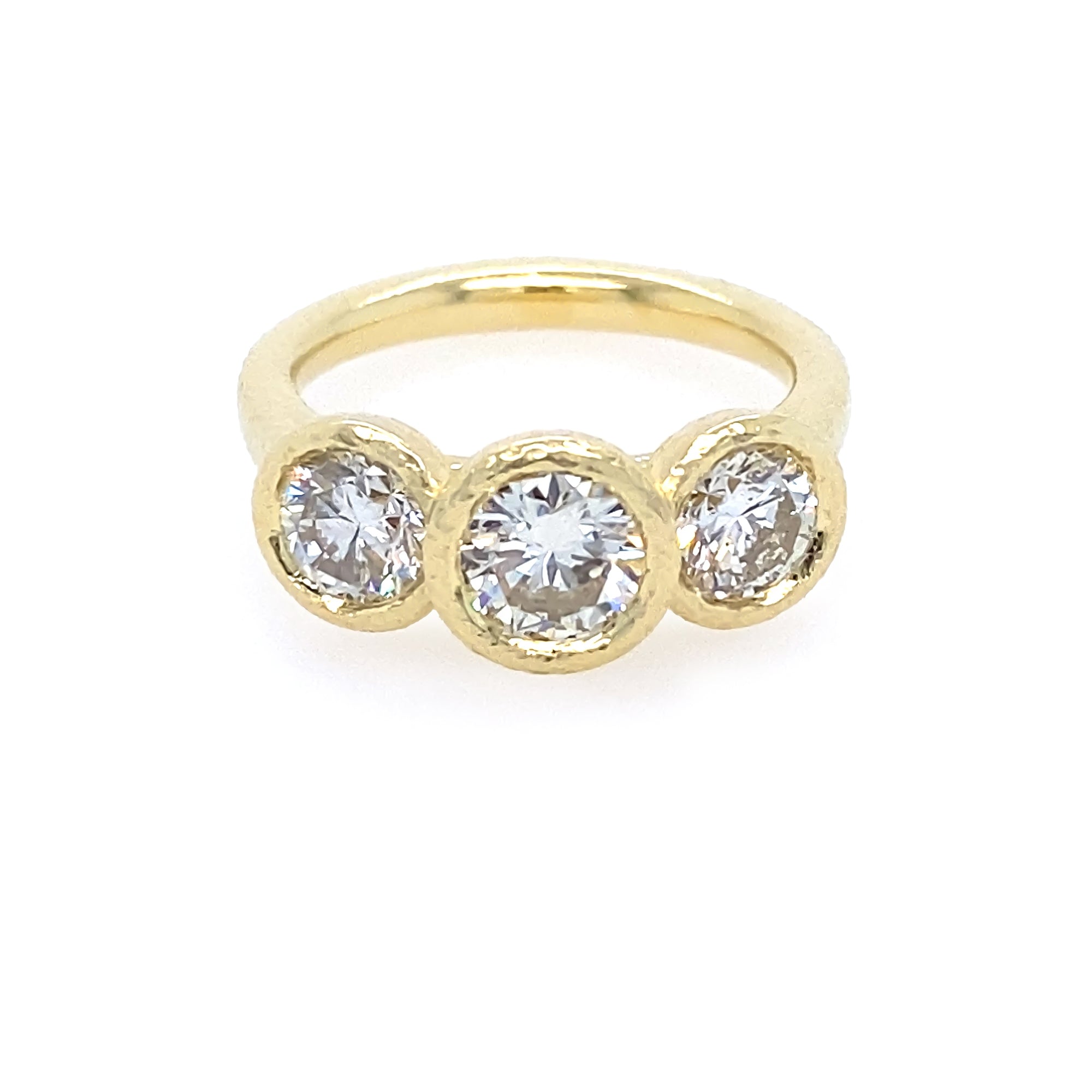 18K Gold ring with three clear diamonds on a white background