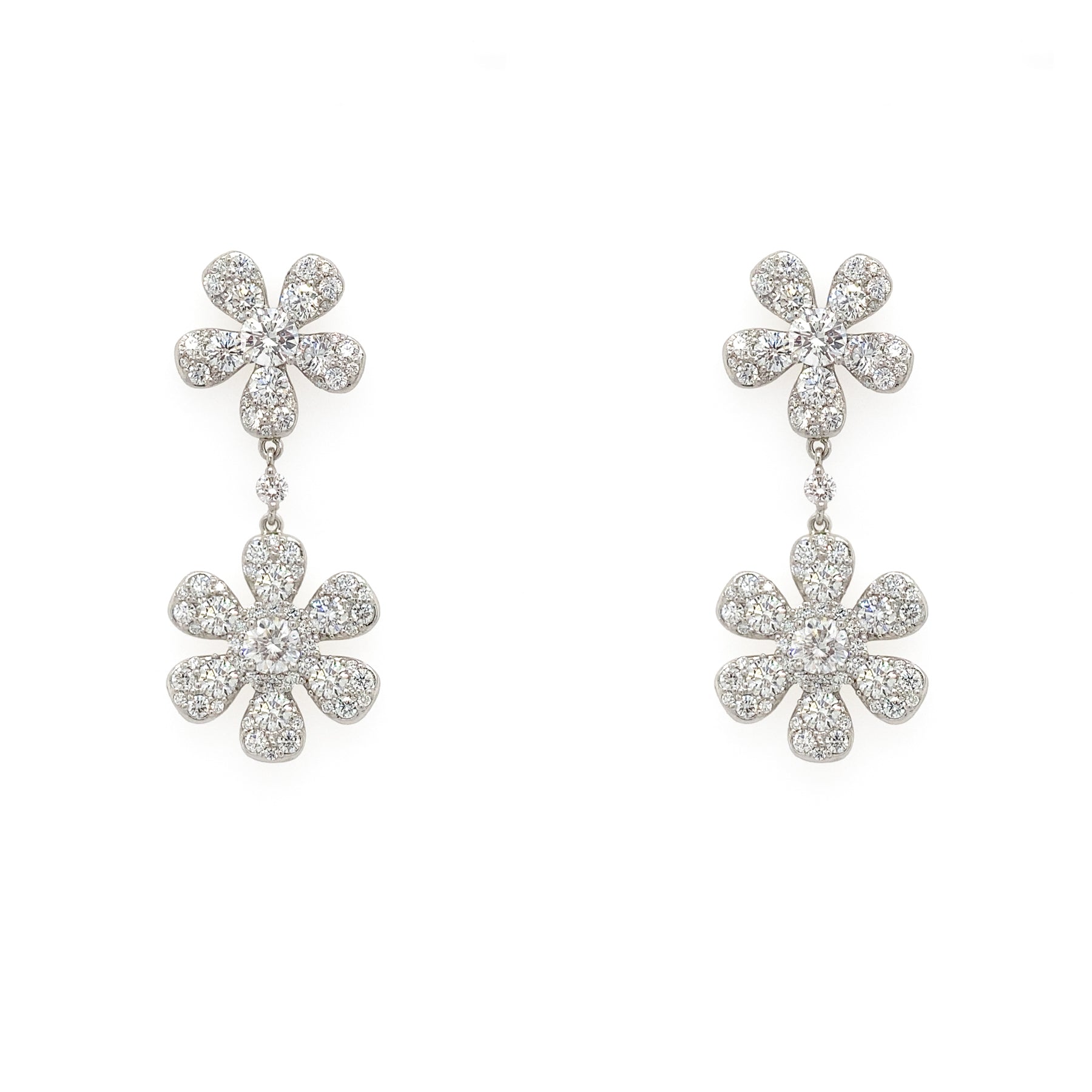 A pair of platinum and diamond flower drop earrings with floral design 