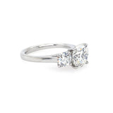 Round brilliant cut three stone diamond engagement ring in platinum - side view