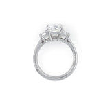 A platinum ring featuring a rectangular clear center diamond and two smaller side diamonds, shown from a side view on a plain white background.