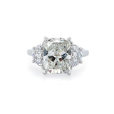 A platinum engagement ring featuring a large central diamond with smaller diamonds on either side.