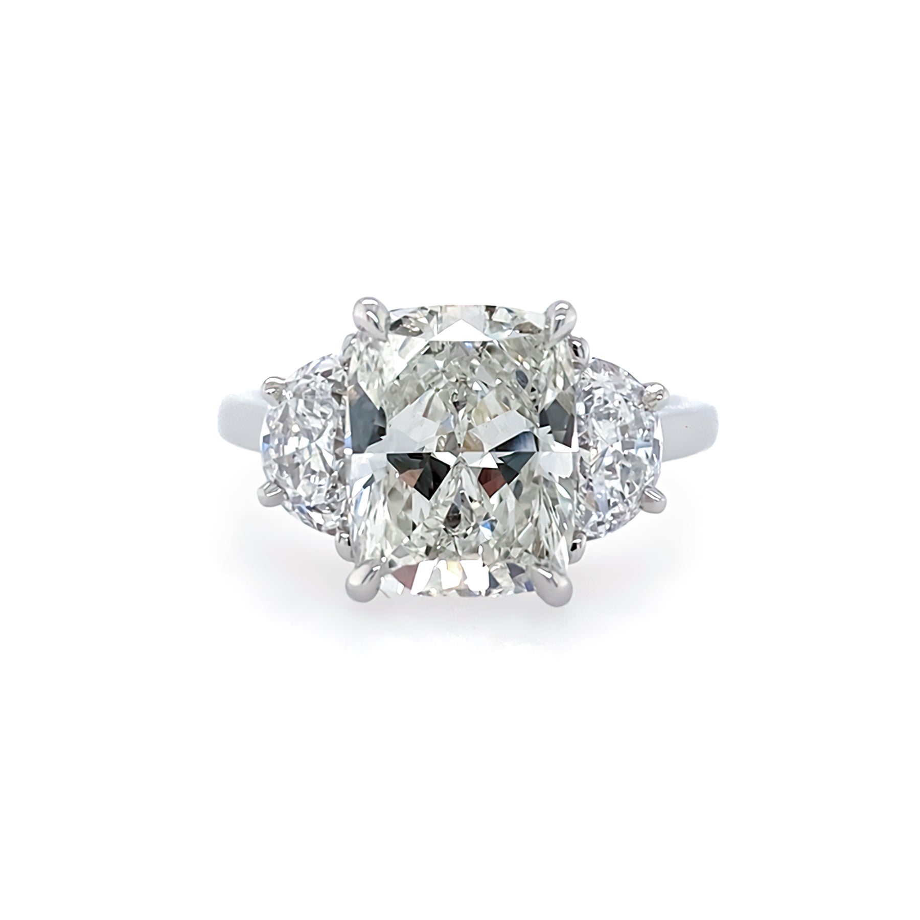 A platinum engagement ring featuring a large central diamond with smaller diamonds on either side.