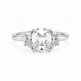 A three-stone diamond ring featuring a large Old Mine center diamond flanked by two smaller half moon diamonds on a polished platinum band, set against a plain white background.