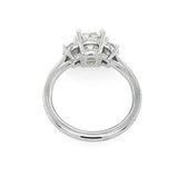 A platinum diamond ring with an old mine cut center diamond and smaller half moon side stones, shown from the back on a plain white background.