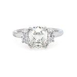 A three-stone diamond engagement ring featuring a central old-mine-cut diamond flanked by two half-moon diamonds on a polished platinum band, set against a plain white background.