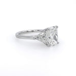 A classic diamond engagement ring featuring a rectangular cushion-cut center stone in a platinum setting on a plain white background.