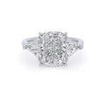 A three-stone diamond ring featuring a large rectangular cushion-cut center stone with two trillion side diamonds, set in a polished platinum band on a white background.