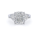 A three-stone diamond ring featuring a large rectangular cushion-cut center stone with two trillion side diamonds, set in a polished platinum band on a white background.