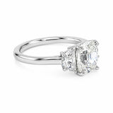 A three-stone diamond ring featuring a central Old Mine cut diamond flanked by two half moon cut diamonds on a polished platinum band, set against a clean white background.