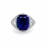 A ring with a large blue tanzanite gemstone surrounded by smaller clear diamonds