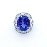 A Custom Designed ring with a blue tanzanite gemstone surrounded by  smaller diamonds.