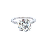 A classic solitaire engagement ring featuring a round brilliant-cut diamond set in a platinum metal band with a prong-set diamonds around the band