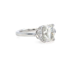 Diamond ring with a a cushion cut diamond and epaulette side stones