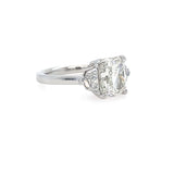 Diamond ring with a a cushion cut diamond and epaulette side stones