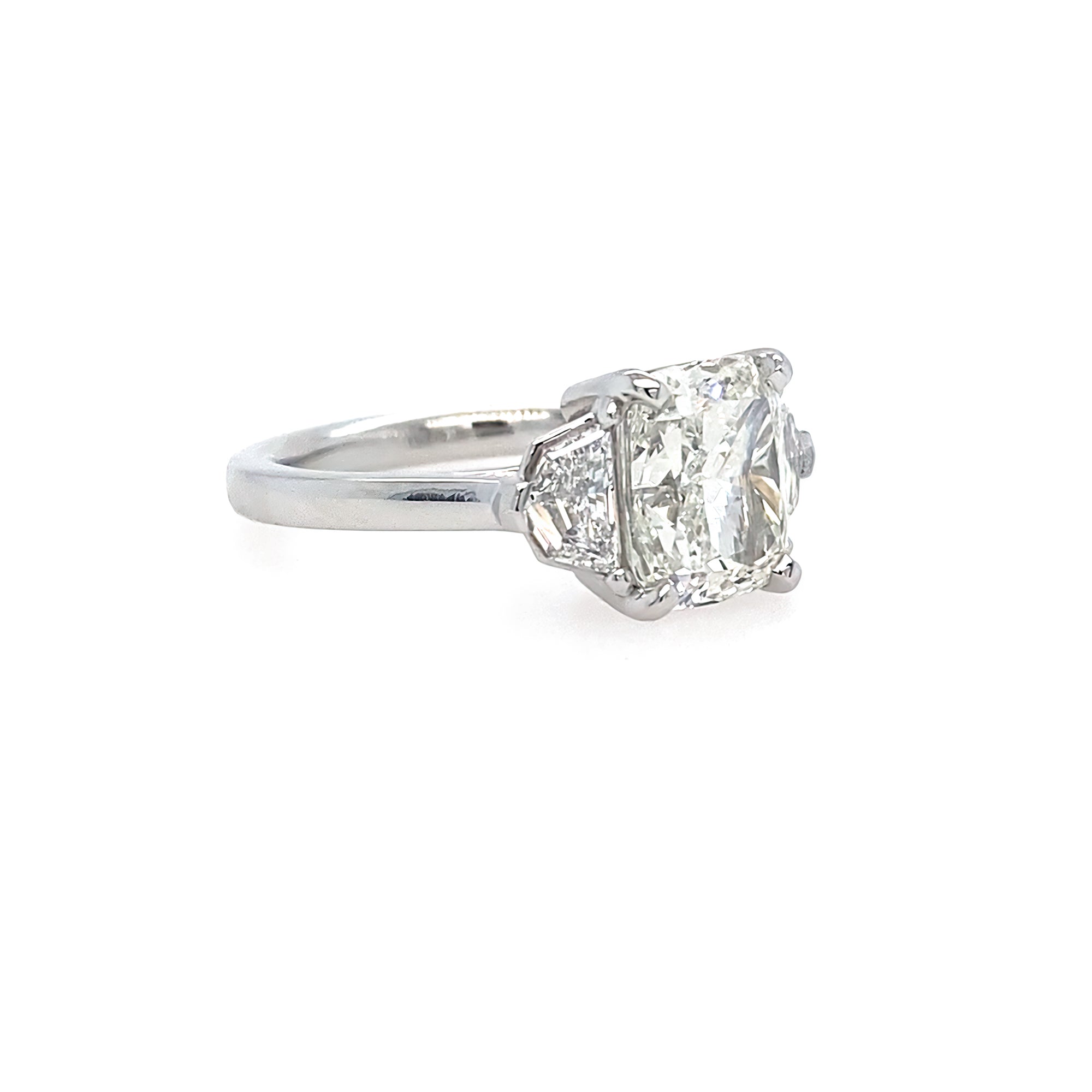 Diamond ring with a a cushion cut diamond and epaulette side stones