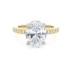 two toned gold ring with oval diamond center stone and with diamonds on the band