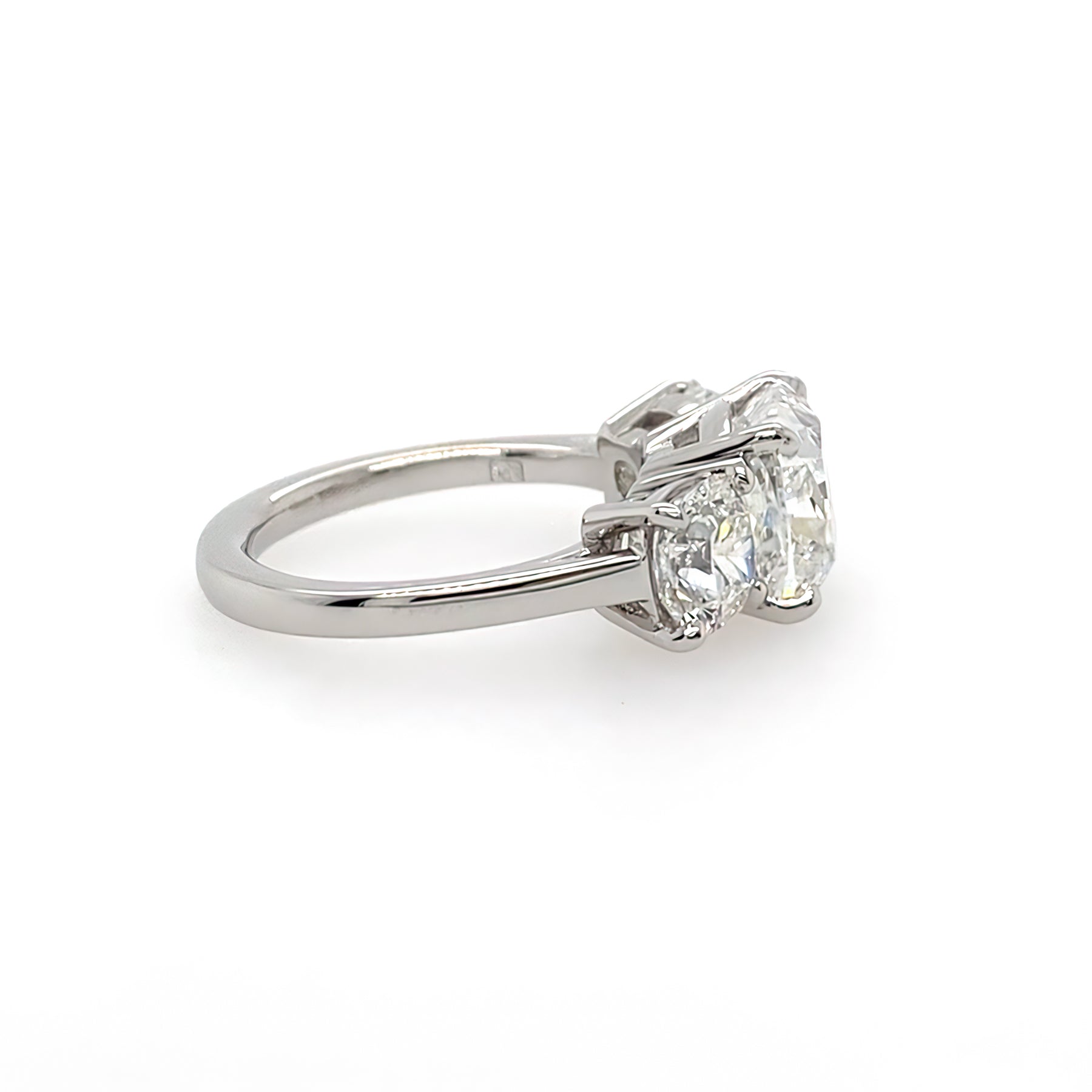 sideview of three stone diamond cushion cut ring