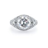 A custom designed platinum band ring with a central diamond and smaller diamonds set around it.