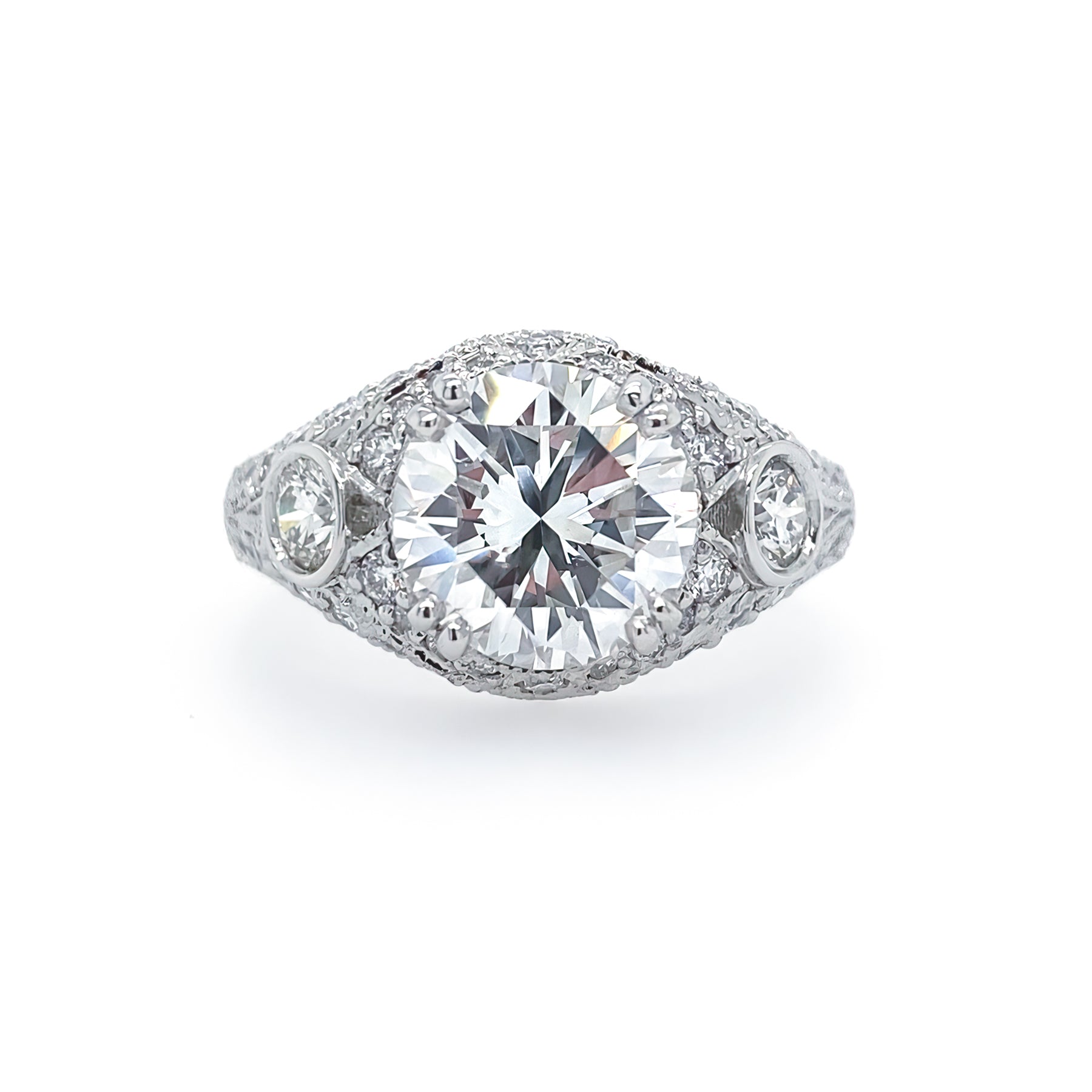 A custom designed platinum band ring with a central diamond and smaller diamonds set around it.