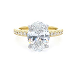 two toned gold ring with oval diamond center stone and with diamonds on the band