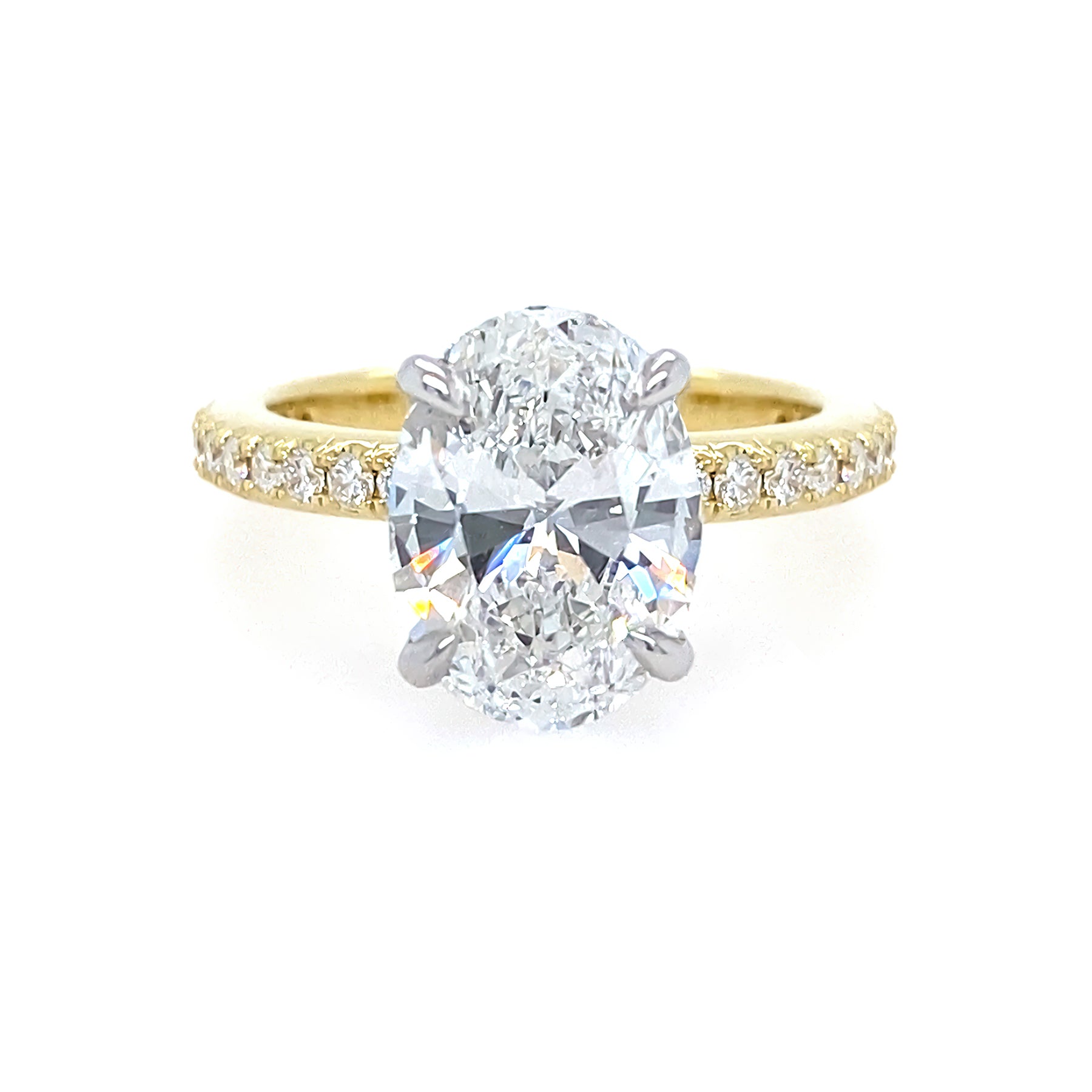 two toned gold ring with oval diamond center stone and with diamonds on the band