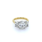 An 18K yellow gold three stone oval diamond ring with platinum prongs.