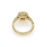 An 18K yellow gold ring with decorative pavé-set diamonds and a center diamond, shown from a top-down view on a white background.