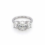 A custom designed three-stone diamond ring featuring a large oval center diamond flanked by two oval side diamonds, set in a polished platinum band against a plain white background.